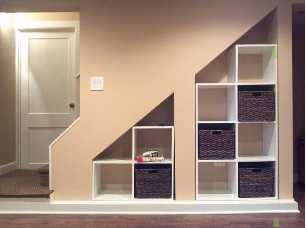 Under-the-stairs storage area with multiple large shelves.