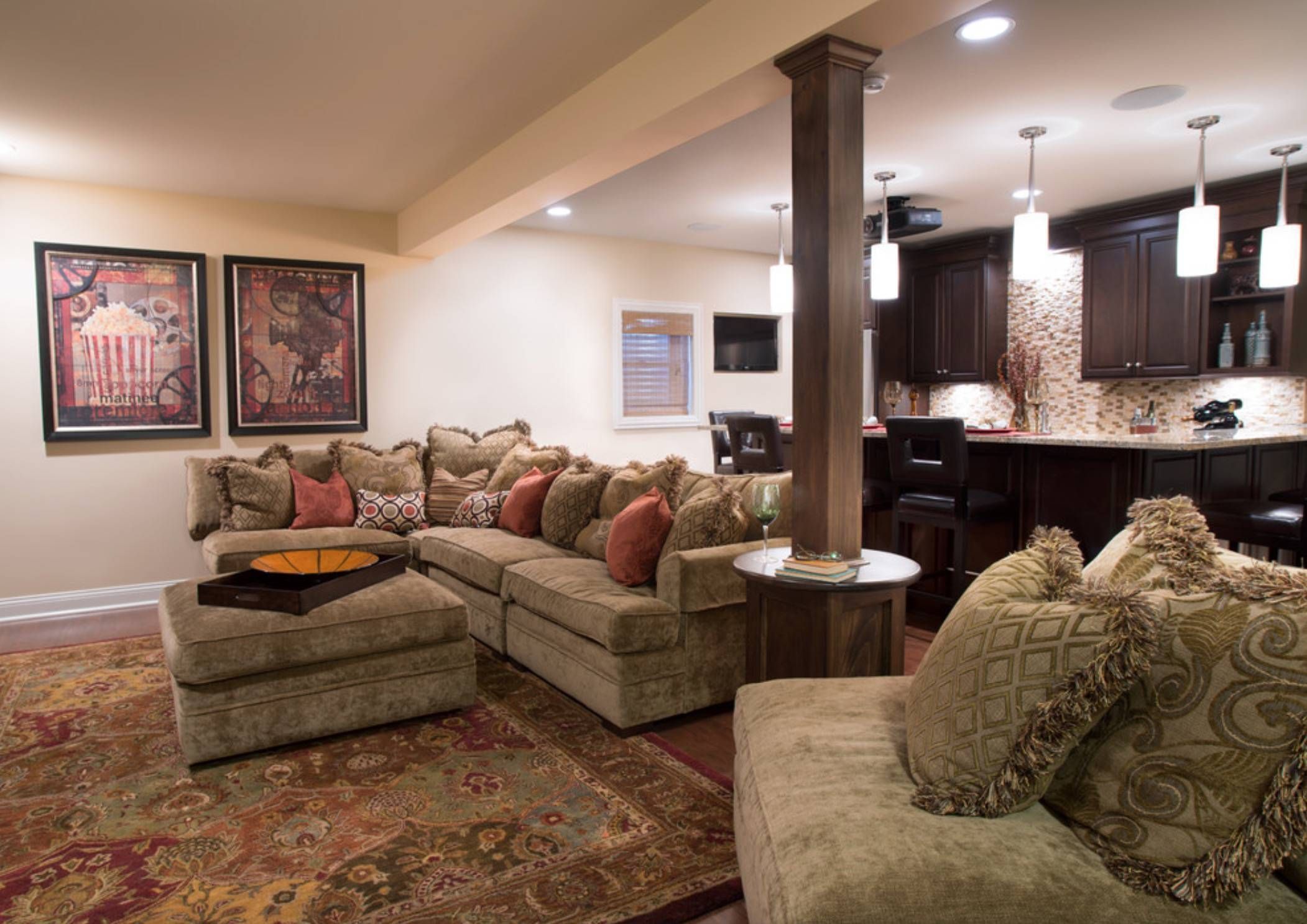 Living room area with small kitchen, cleverly tied together with a single column design.