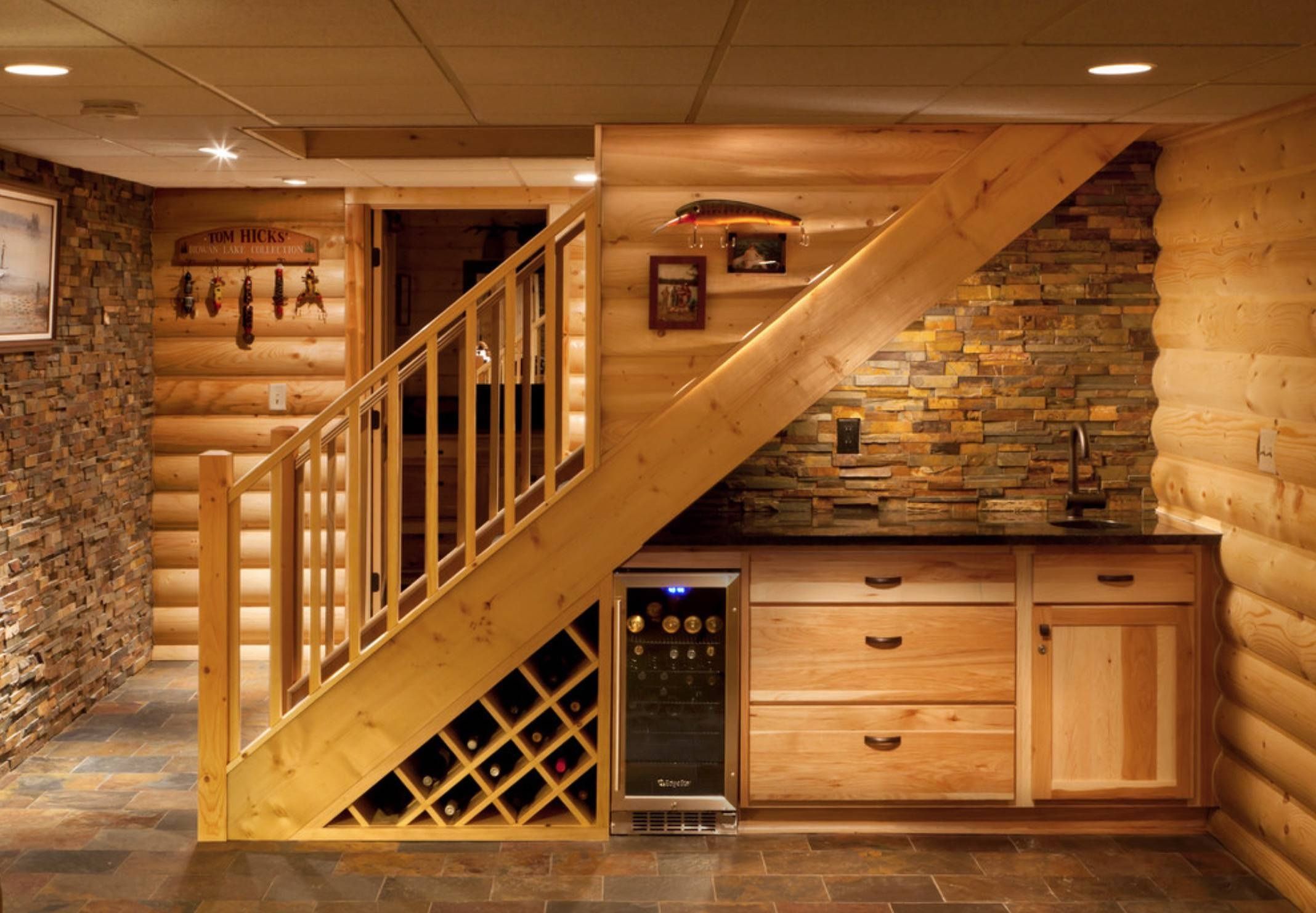 An under-the-stairs basement wet bar design with open shelving and a wine bar.