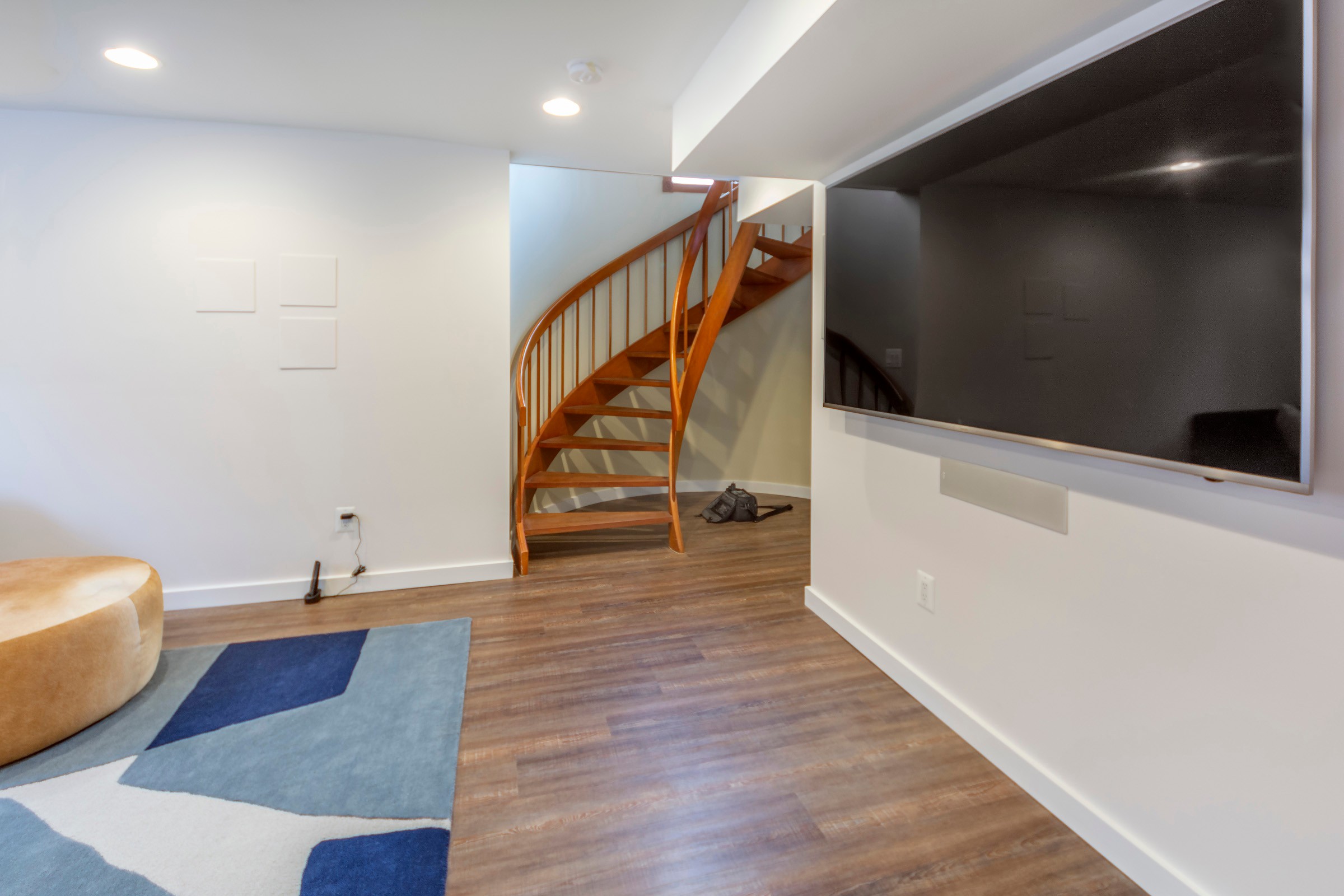 High End Basement Remodel - Wooden Stair Steps, LVT Flooring and White ...