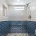 Renovated basement with a pet shower and tiled flooring