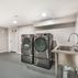 Renovated basement with a pet shower and tiled flooring