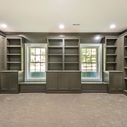 Large basement finishing with wet-bar and built-ins.