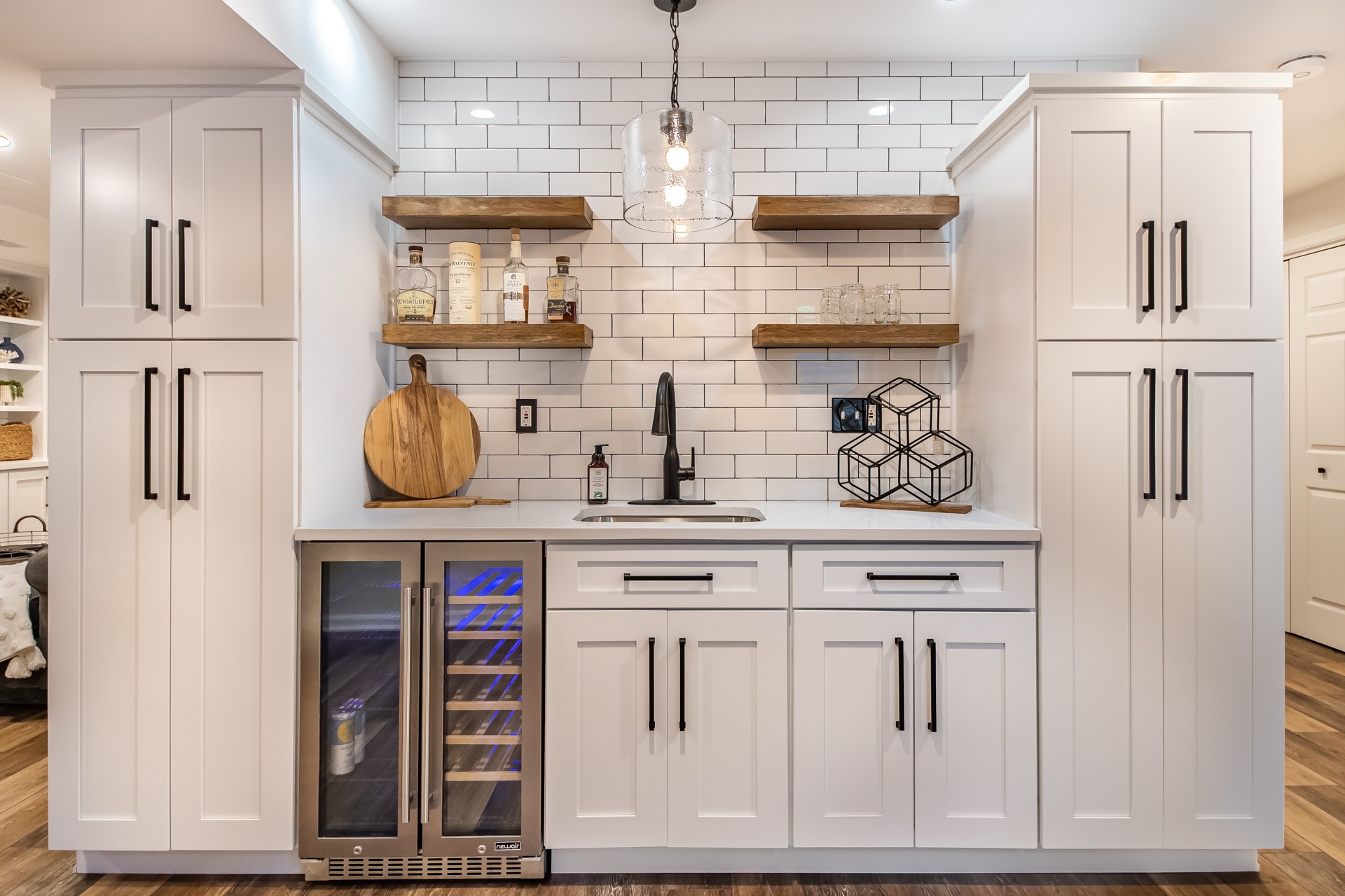 Welcoming basement finishing with beautiful built-ins and small wet-bar
