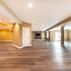 Modern Basement Design with Custom Wet Bar and Elegant Finishes