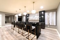 Sophisticated Basement Remodel with Stylish Wet Bar and Open Layout 