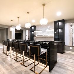 Sophisticated Basement Remodel with Stylish Wet Bar and Open Layout 