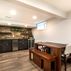 Stylish Basement Remodel with Cozy Entertainment Area and Rustic Wet Bar