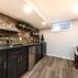 Stylish Basement Remodel with Cozy Entertainment Area and Rustic Wet Bar