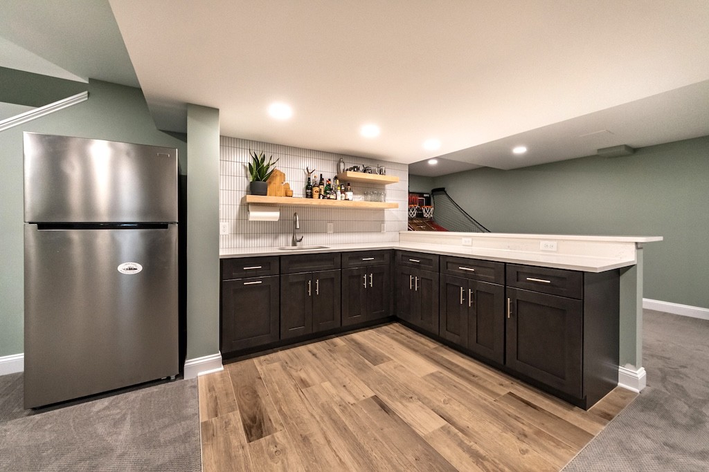 Spacious Basement Remodel with Modern Wet Bar and Entertainment Area 