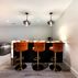 Stylish Basement Renovation with Illuminated Bar and Versatile Living Spaces