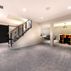 Stylish Basement Renovation with Illuminated Bar and Versatile Living Spaces