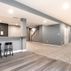 Stylish Basement Transformation with Wet Bar and Multi-Purpose Layout