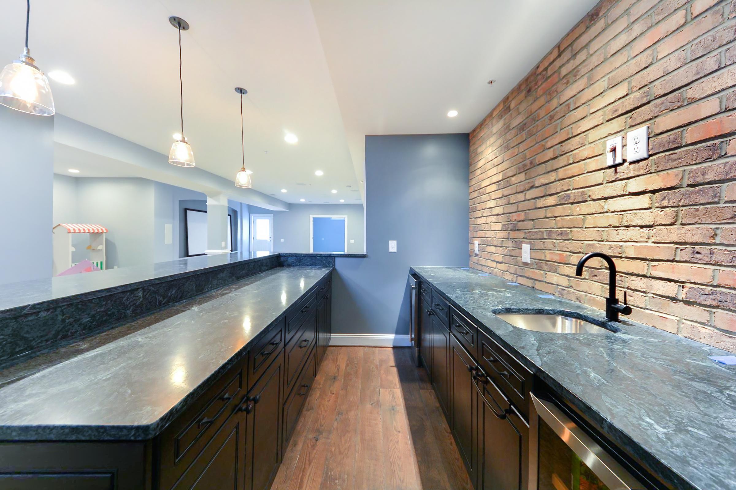 Basement Renovation Exposed Brick with Hanging Lights