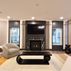 Sophisticated basement retreat with a marble-topped bar and a moody stone fireplace in Lutherville, MD, Lutherville, MD