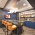 Sophisticated basement retreat with a marble-topped bar and a moody stone fireplace in Lutherville, MD, Lutherville, MD