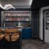 Sophisticated basement retreat with a marble-topped bar and a moody stone fireplace in Lutherville, MD, Lutherville, MD