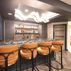 Sophisticated basement retreat with a marble-topped bar and a moody stone fireplace in Lutherville, MD, Lutherville, MD