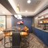 Sophisticated basement retreat with a marble-topped bar and a moody stone fireplace in Lutherville, MD, Lutherville, MD