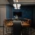 Sophisticated basement retreat with a marble-topped bar and a moody stone fireplace in Lutherville, MD