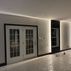 Sophisticated basement retreat with a marble-topped bar and a moody stone fireplace in Lutherville, MD