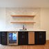 A 1,336 sq. ft. basement renovation with a stacked-stone fireplace, custom wet bar, and private suite, Fairfax, VA