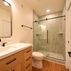 A 1,336 sq. ft. basement renovation with a stacked-stone fireplace, custom wet bar, and private suite, Fairfax, VA