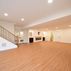 A 1,336 sq. ft. basement renovation with a stacked-stone fireplace, custom wet bar, and private suite, Fairfax, VA