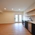 A 1,336 sq. ft. basement renovation with a stacked-stone fireplace, custom wet bar, and private suite, Fairfax, VA