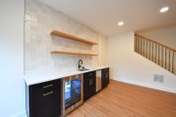 Stacked-stone fireplace, custom wet bar, full bath, gym and private suite