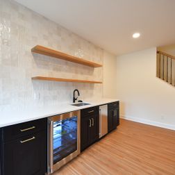 Stacked-stone fireplace, custom wet bar, full bath, gym and private suite, Fairfax, VA