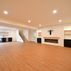 A 1,336 sq. ft. basement renovation with a stacked-stone fireplace, custom wet bar, and private suite, Fairfax, VA
