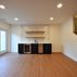 A 1,336 sq. ft. basement renovation with a stacked-stone fireplace, custom wet bar, and private suite, Fairfax, VA