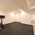 A 1,336 sq. ft. basement renovation with a stacked-stone fireplace, custom wet bar, and private suite, Fairfax, VA