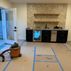A 1,336 sq. ft. basement renovation with a stacked-stone fireplace, custom wet bar, and private suite, Fairfax, VA
