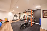 Herringbone-tiled bathroom, wet bar, bedroom and home gym