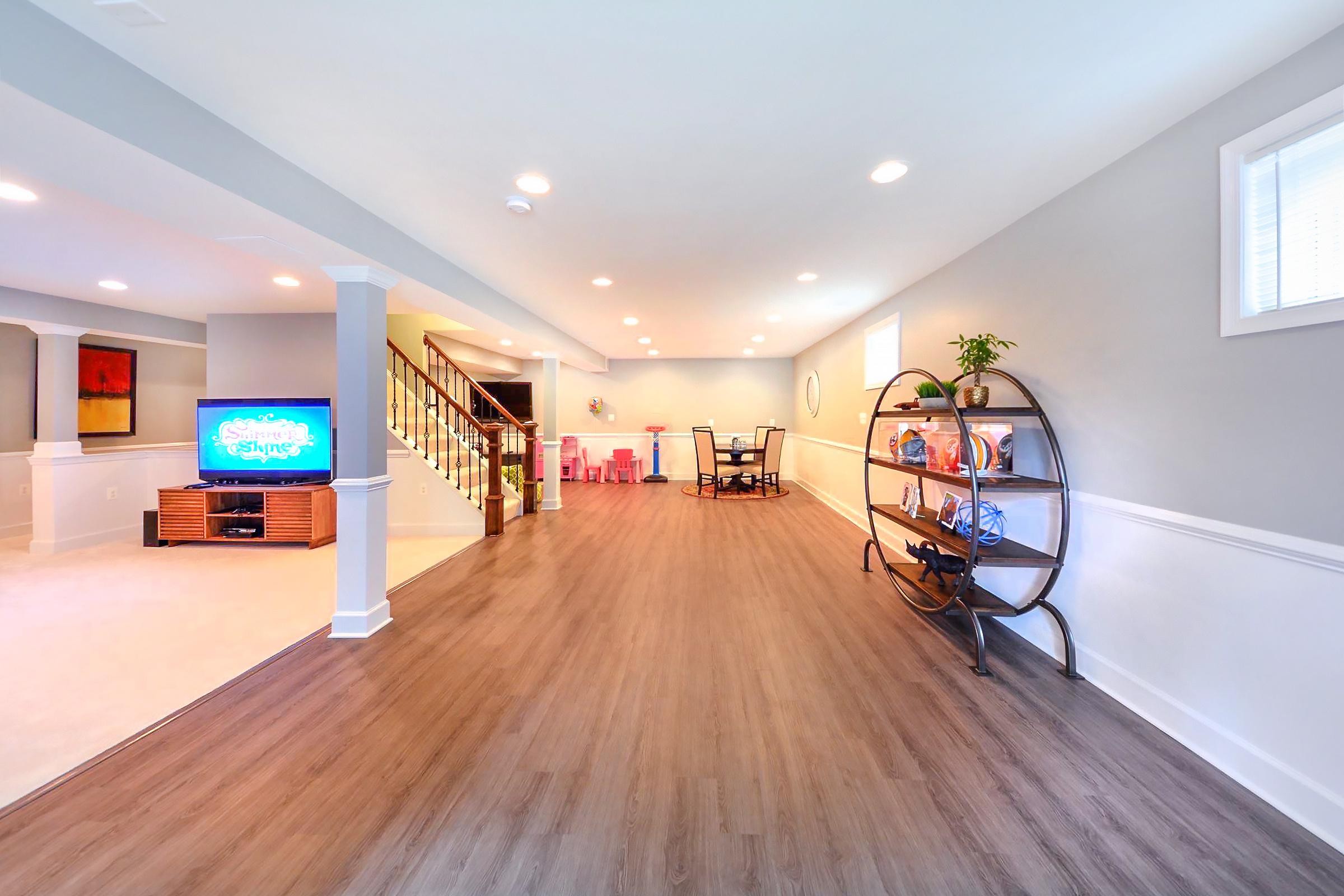 Basement Finishing - Stair Railing, Large Family Room And White Bathroom