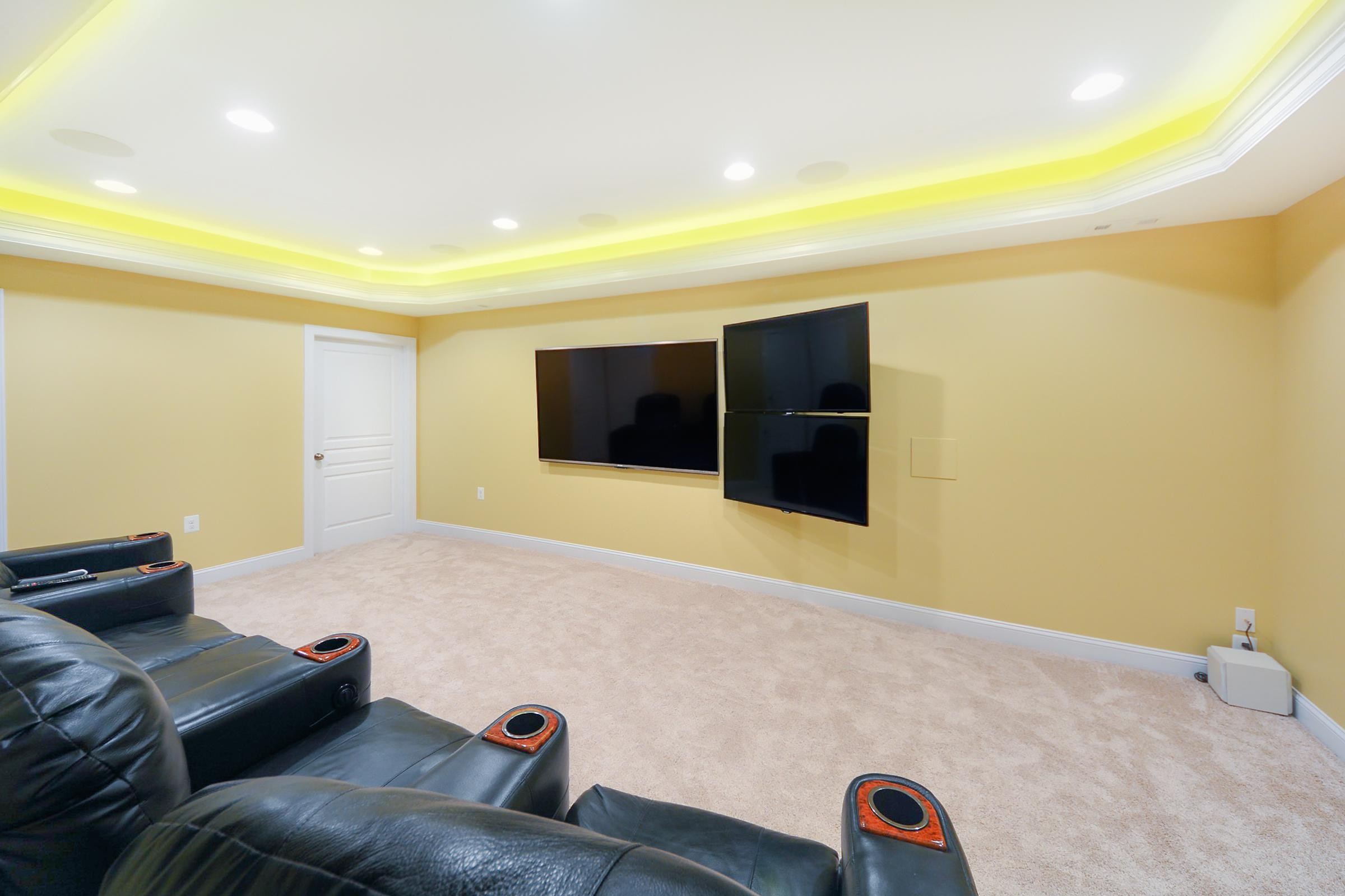 Basement TV Setup in A Yellow Home Theater
